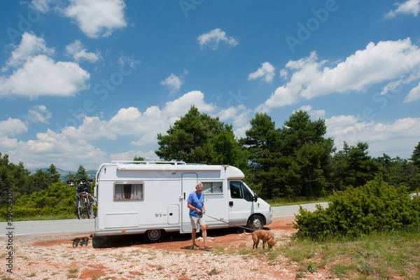 Fototapeta Man is traveling by mobile home