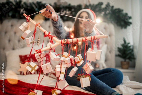 Fototapeta advent calendar in the hands of a girl, a surprise in a box, christmas gifts