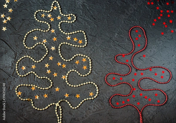 Fototapeta Gold and red decorations in the form of a Christmas tree on a black background.