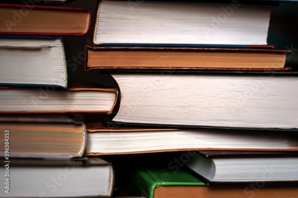Fototapeta Stack of books.The background of the books.