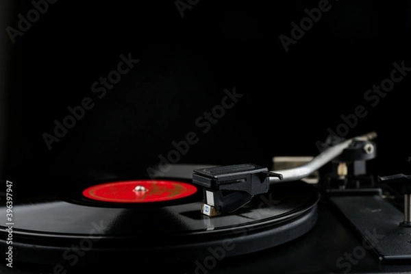 Fototapeta vinyl record on a turntable. turntable head close-up on black background with copy space