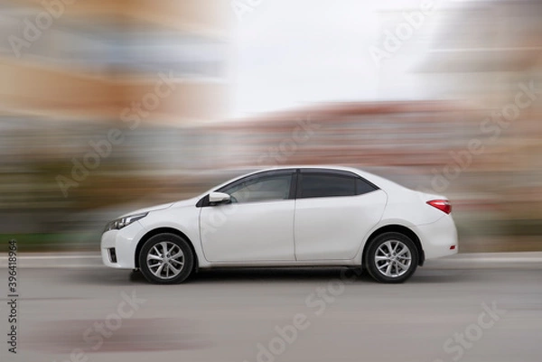 Fototapeta fast speed modern car moving through the city, motion blur urban concept