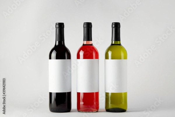 Fototapeta Mockup. Bottles of wine of different types isolated on a white background.