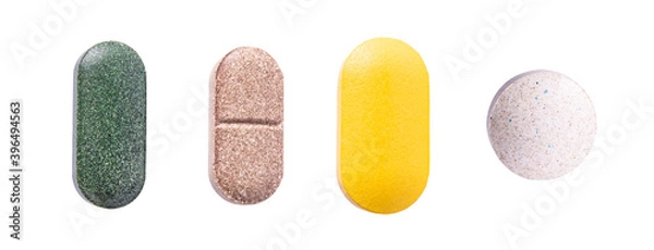 Fototapeta Pills set of supplements, vitamins and medication. Nutrition pills, healthy natural medication. Vitamin C, spirulina and biotin macro photo isolated on white background.