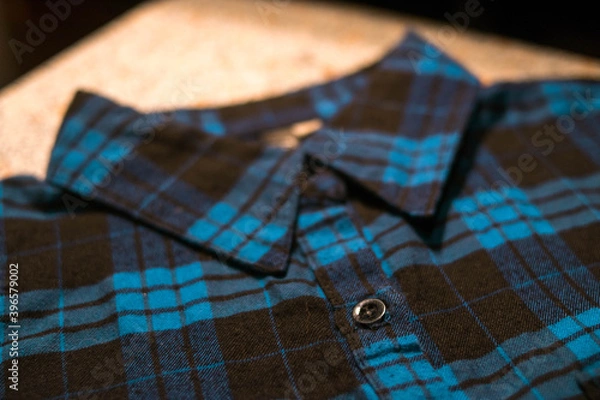 Obraz Collar of a dark blue plaid shirt with black buttons