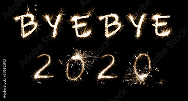 Fototapeta Bye Bye 2020. Bright text made of sparkler on black background, banner design