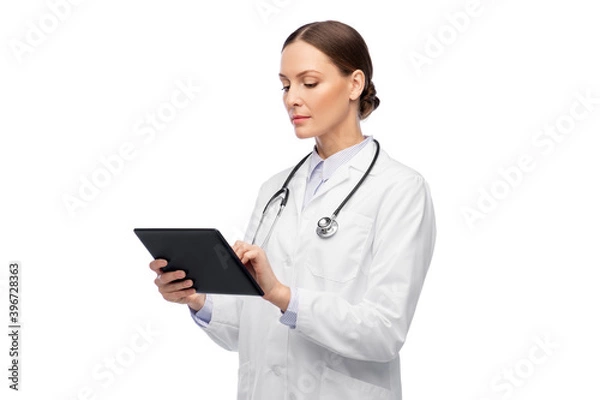 Fototapeta medicine, profession and healthcare concept - female doctor in white coat with tablet pc computer and stethoscope