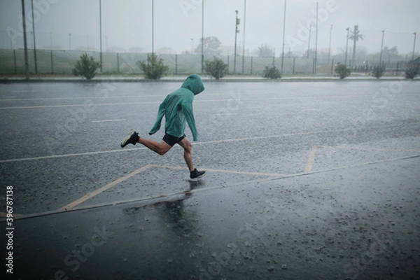 Obraz man runs in the rain