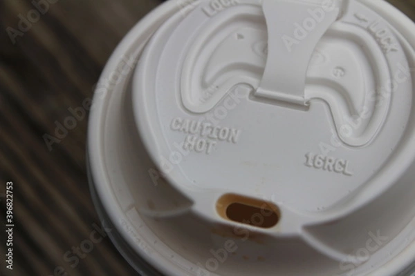 Fototapeta Looking down on a to go coffee drink with coffee stains on the mouth of the lid.