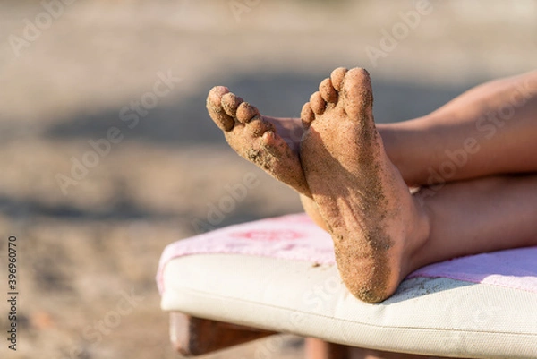 Obraz Close up on young woman feet covered in sand. Concept for relaxation on the beach druing the hot summer days. Travel vacation near the sea.