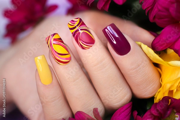 Obraz Nail design on shiny and matte nail Polish with smooth curves.Fashionable multicolored manicure.