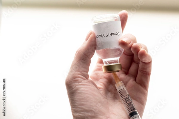 Obraz a vial with a medicine for the coronavirus, a vaccine for covid-19 with a syringe and needle