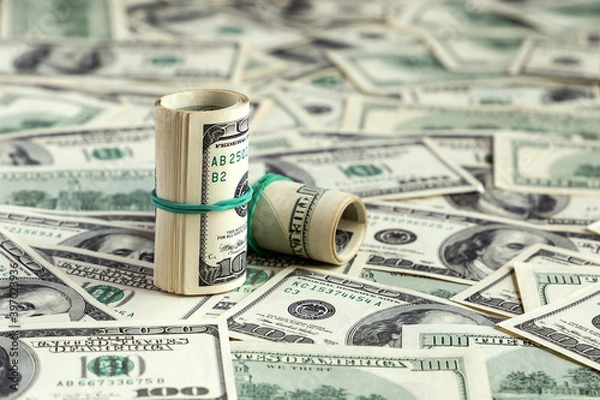 Fototapeta One hundred dollars banknotes, bundles and rolls background. US dollar bills texture or pattern. Money, finance, business concept. Close up, top view. Currency and savings. American