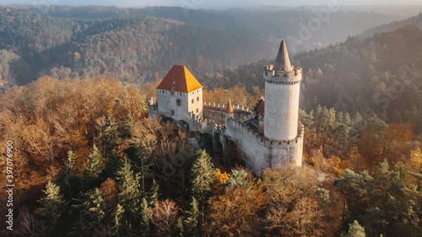 Fototapeta Aerial fall view of old stone Kokorin Castle built in 14th century.It lies in the middle of nature reserve on a steep rocky spur above the Kokorin Valley.Popular historical monument in Czech republic.