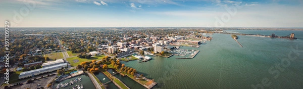 Obraz Incredible aerial city skyline panorama photograph of Sandusky, Ohio from the shoreline of the bay in Lake Erie with parks and harbors seen below on a sunny day.