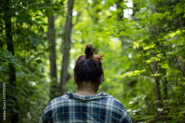Obraz Person walking through forest