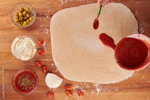 Obraz Making italian pizza step by step: adding tomato sauce