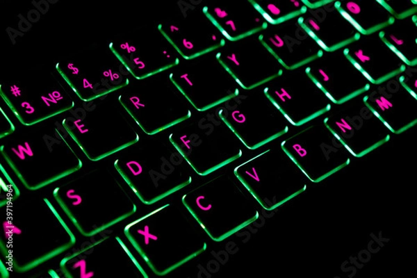 Fototapeta Close up view of a modern laptop computer keyboard key with green buttonss. Pc computer keyboard close up
