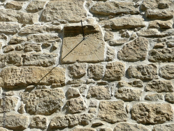 Fototapeta Ruined statue coming out of an old building's corner