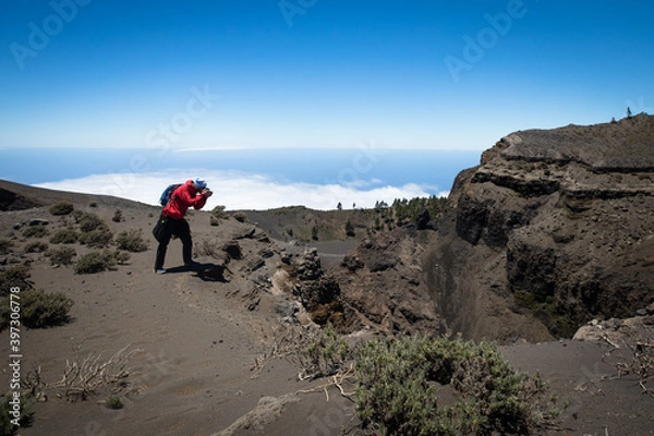 Obraz man hiking and photographing volcanic nature on canary islands