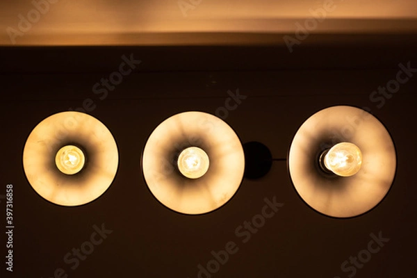 Obraz Three round lamps on the ceiling, bottom view