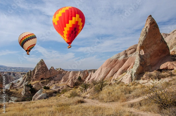 Obraz Bright balloons hover over a valley in Cappadocia. Turkey