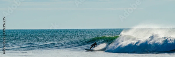 Obraz Vendée, France; November 29, 2020: from the Sauzaie spot, a black silhouette of a surfer on the point break, Bretignolles Sur Mer.

