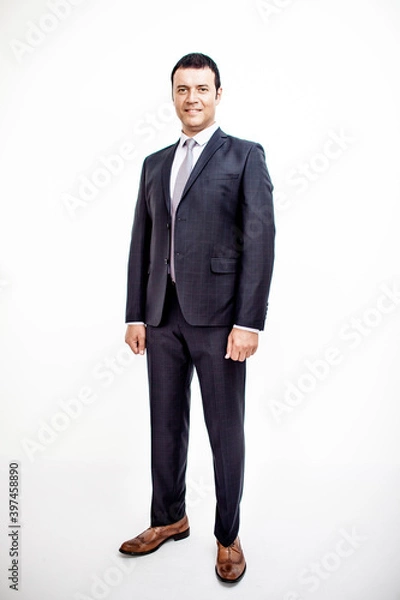 Fototapeta A man in a classic suit. Studio photo on a white background. Snapshot as for a catalog.