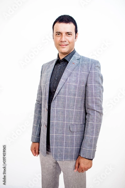 Fototapeta A man in a classic suit. Studio photo on a white background. Snapshot as for a catalog.