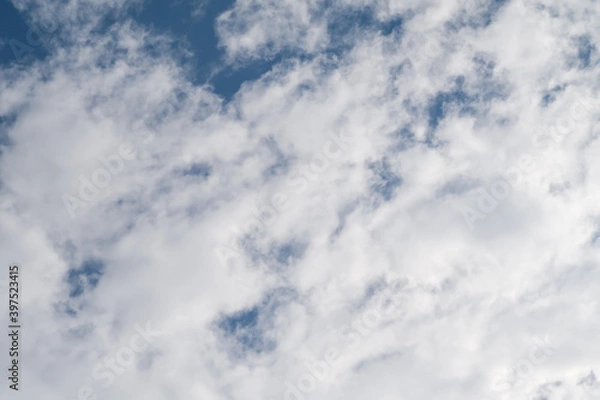 Fototapeta Altocumulus clouds against blue sky background.