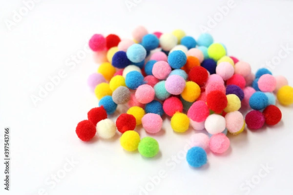 Obraz Fur pom-poms on a white background. Multi-colored fluffy balls. Concept - needlework, decor, handmade. There is room for text.