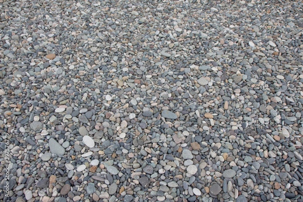 Fototapeta abstract background with round peeble round stones. Pile of stones on beach