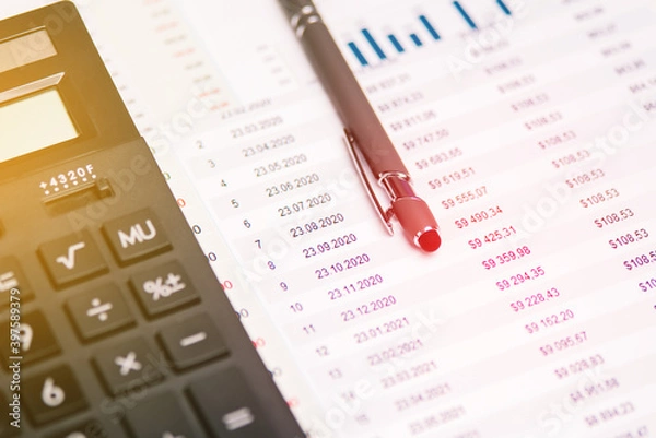 Fototapeta Accounting. Calculator, pen and documents with numbers at the workplace. Calculation of taxes.