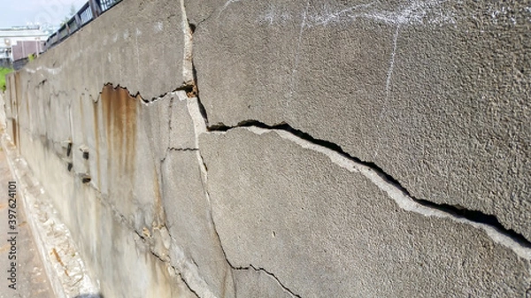 Fototapeta cracks and chips on the ruined foundation of the old building structure
