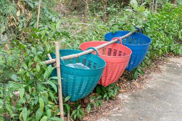 Fototapeta The colorful trash in the park lined up.