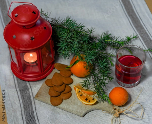 Obraz Christmas composition with candle, juniper branch and glass of juice
