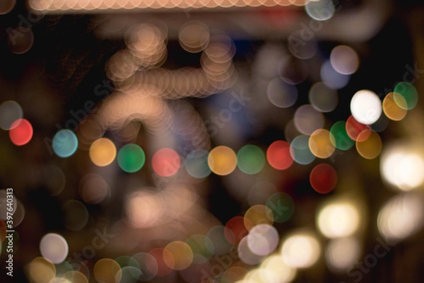 Fototapeta Multicolored bokeh circles on a dark background.