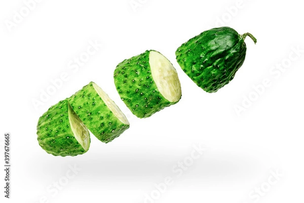 Fototapeta Cucumber cut into pieces on a white background. Isolated. Levitation