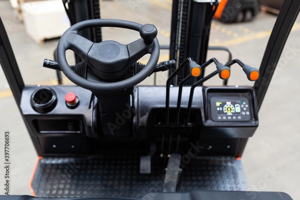Fototapeta Detail of forklift cabin on warehouse. Industrial background