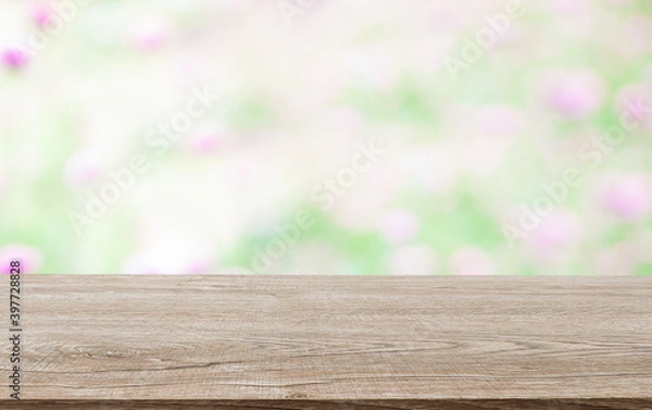 Fototapeta Wooden decking with space for placement of advertising materials. And with a flower background