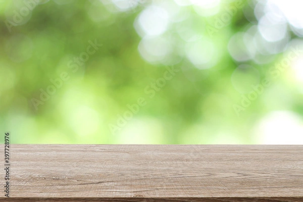 Fototapeta Wooden decking with space for placement of advertising materials. And has a blurred background, bokeh, can be used as a background advertising