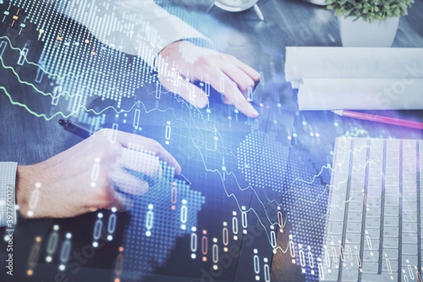 Fototapeta Double exposure of man's hands holding and using a phone and financial graph drawing. Analysis concept.
