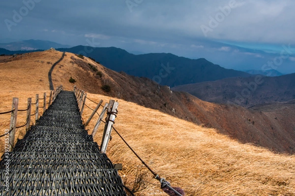 Fototapeta Landscape of the mountain ridge and path at Sobaeksan National Park in Danyang, South Korea during a cloudy day. 
