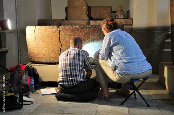 Obraz Egyptologists deciphering hieroglyphs in the Egyptian Museum, Cairo