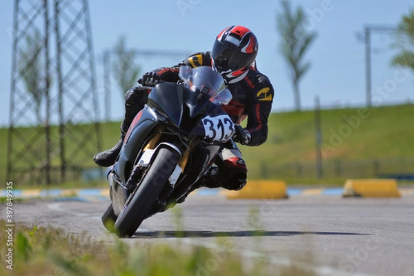 Obraz Motorcycle practice leaning into a fast corner on track