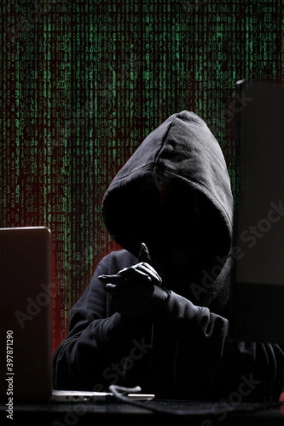 Fototapeta International hacker in black pullover and black mask trying to hack government on a black and red background. Cyber crime . Cyber security. Matrix effect