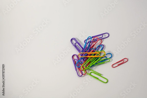 Obraz Office colored paper clips on a white background