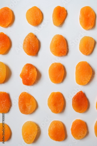 Fototapeta Dry apricots placed on a white board. Place for text 