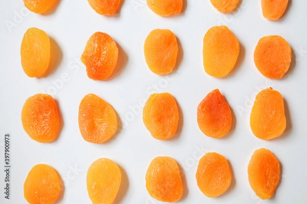Fototapeta Dry apricots placed on a white board. Place for text 