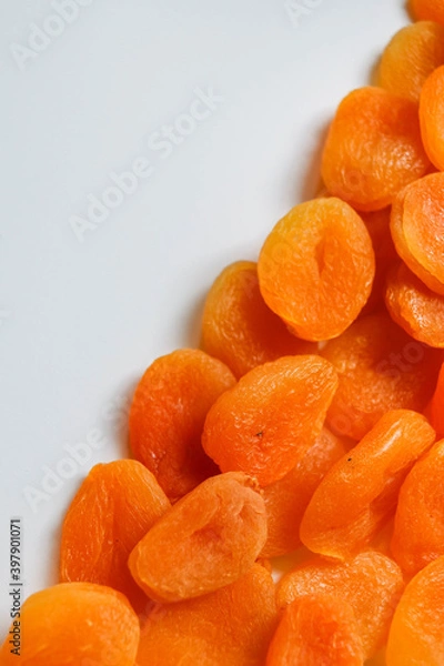 Fototapeta Dry apricots placed on a white board. Place for text 
